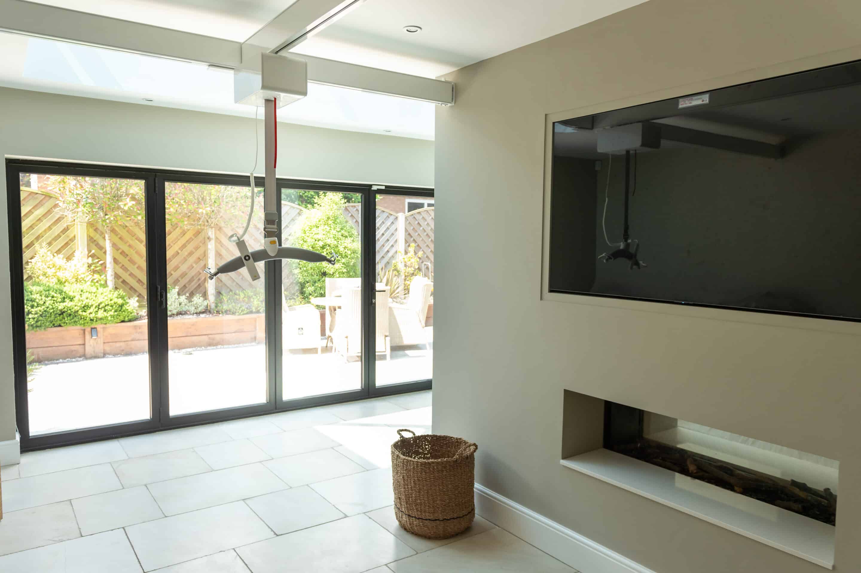 Guldmann GH3 ceiling hoist installation in a private home, with an overhead track system providing room coverage.